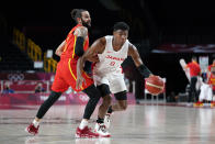 Japan's Rui Hachimura (8) drives past Spain's Rudy Fernandez (5) during a men's basketball preliminary round game at the 2020 Summer Olympics in Saitama, Japan, Monday, July 26, 2021. (AP Photo/Charlie Neibergall)