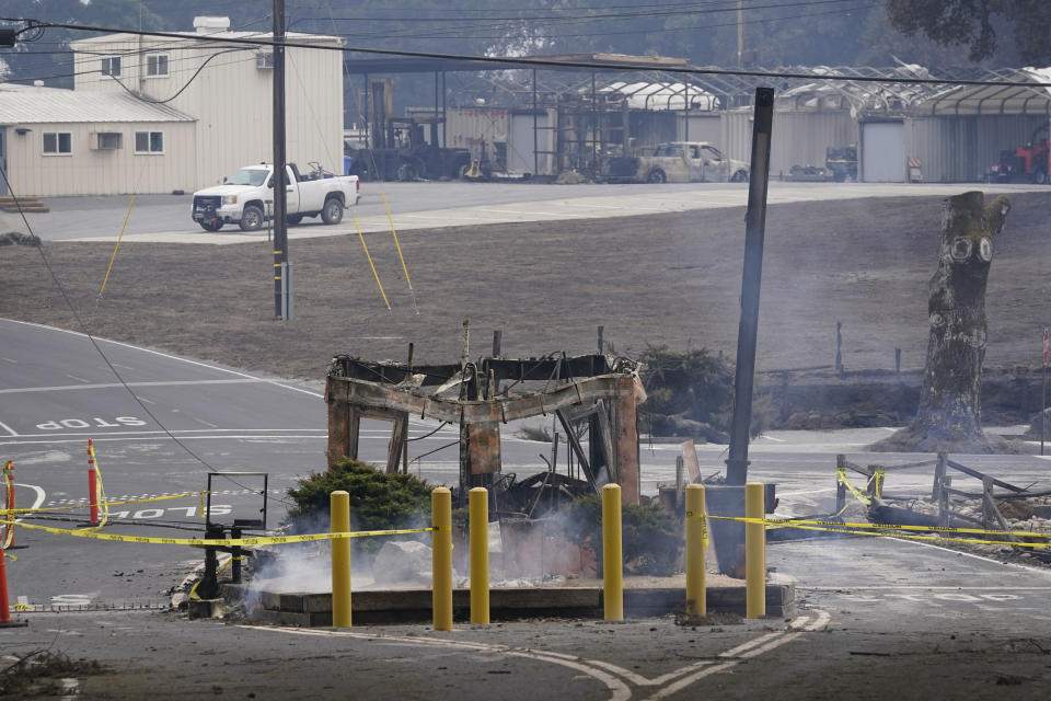 A fired-damaged kiosk is seen at the entrance of the Lockheed Martin campus after the CZU Lightning Complex Fire went through the area Sunday, Aug. 23, 2020, in Bonny Doon, Calif. (AP Photo/Marcio Jose Sanchez)