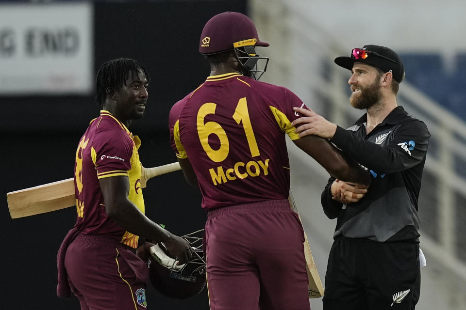 New Zealand's captain Kane Williamson shakes hands with West Indies' Obed McCoy at the end of the second T20 cricket match at Sabina Park in Kingston, Jamaica, Friday, Aug. 12, 2022. New Zealand won by 90 runs. (AP Photo/Ramon Espinosa)