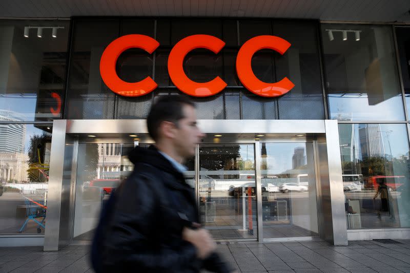 A man walks outside Polish shoe retailer CCC shop in Warsaw