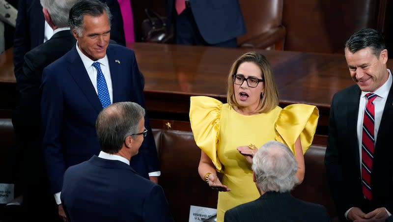 Sen. Kyrsten Sinema, I-Ariz., center, speaks with Sen. Mitt Romney, R-Utah, left, and Sen. Todd Young, R-Ind., right, and others, before President Joe Biden arrives to deliver his State of the Union speech to a joint session of Congress, at the Capitol in Washington, Feb. 7, 2023.