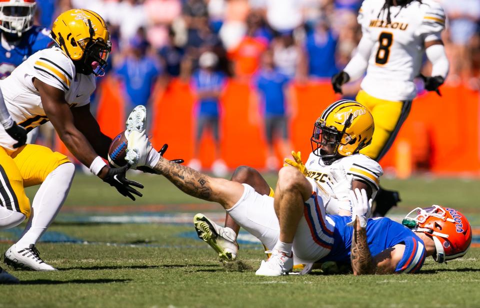 Missouri Tigers defensive back Daylan Carnell (13) comes in to intercept the ball after Missouri Tigers defensive back Jaylon Carlies (1) causes the ball to pop out of Florida Gators wide receiver Ricky Pearsall (1) hands in the fourth quarter at Steve Spurrier Field at Ben Hill Griffin Stadium in Gainesville, FL on Saturday, October 8, 2022. [Doug Engle/Gainesville Sun]
