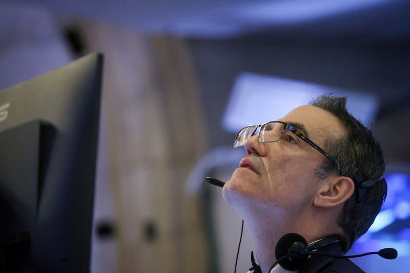 Traders work on the floor of the NYSE in New York