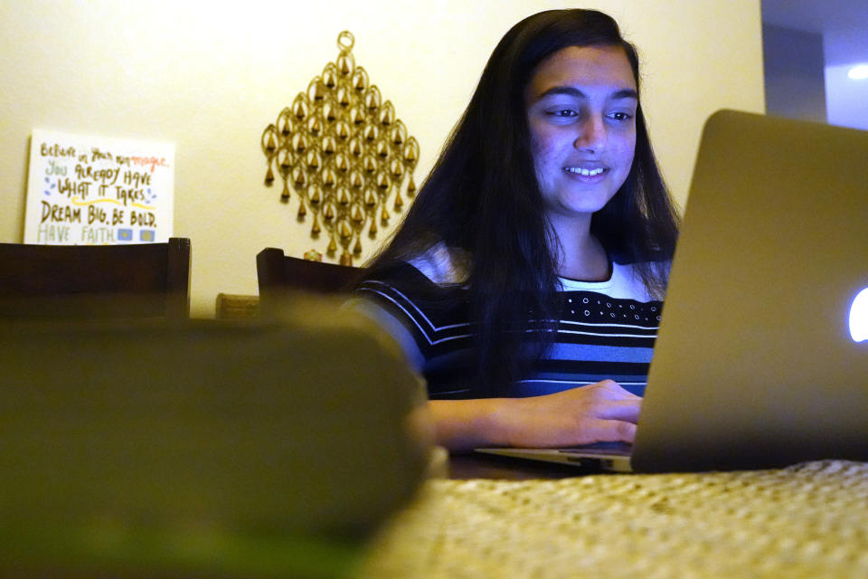 Charvi Goyal, 17, gives an online math tutoring session from her family's home Monday, Jan. 4, 2021, in Plano, Texas. Goyal is part of a group of high school students that put together their own volunteer online tutoring service to help k-12 during the pandemic. (AP Photo/LM Otero)