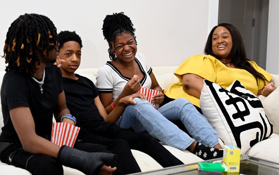 Eric Fitih, left, Ethan Fitih, Jada Fitih and their mother, Samantha Sharpe, joke around before watching a movie at their home on Friday, March 22, 2024, in Nashville, Tenn. Sharpe, a local digital creator, is passionate about social media safety, especially for her three teenage children.