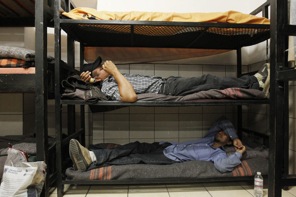 Antonio Perez, bottom, joins dozens of immigrants, many of them Mexican citizens, as they relax in sleeping quarters at a well known immigrant shelter, as many are making tough decisions on whether to try their luck at trying to make it to the United States, by illegally crossing the border, Thursday, Aug. 9, 2012, in Nogales, Mexico. The U.S. government has halted flights home for Mexicans caught entering the country illegally in the deadly summer heat of Arizona's deserts, a money-saving move that ends a seven-year experiment that cost taxpayers nearly $100 million.(AP Photo/Ross D. Franklin) (AP Photo/Ross D. Franklin)