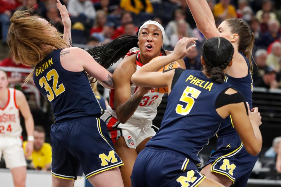 Ohio State forward Cotie McMahon, second from left, looks for space to work as Michigan guards Leigha Brown (32) and Laila Phelia (5) and forward Emily Kiser, far right, defend during the first half of an NCAA college basketball game at the Big Ten Conference women's tournament Friday, March 3, 2023, in Minneapolis. (AP Photo/Bruce Kluckhohn)