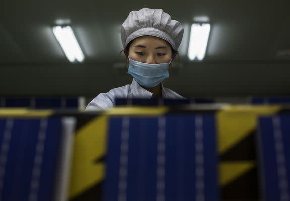 A technician from Yingli Solar prepares solar cells in Hebei Province, China.