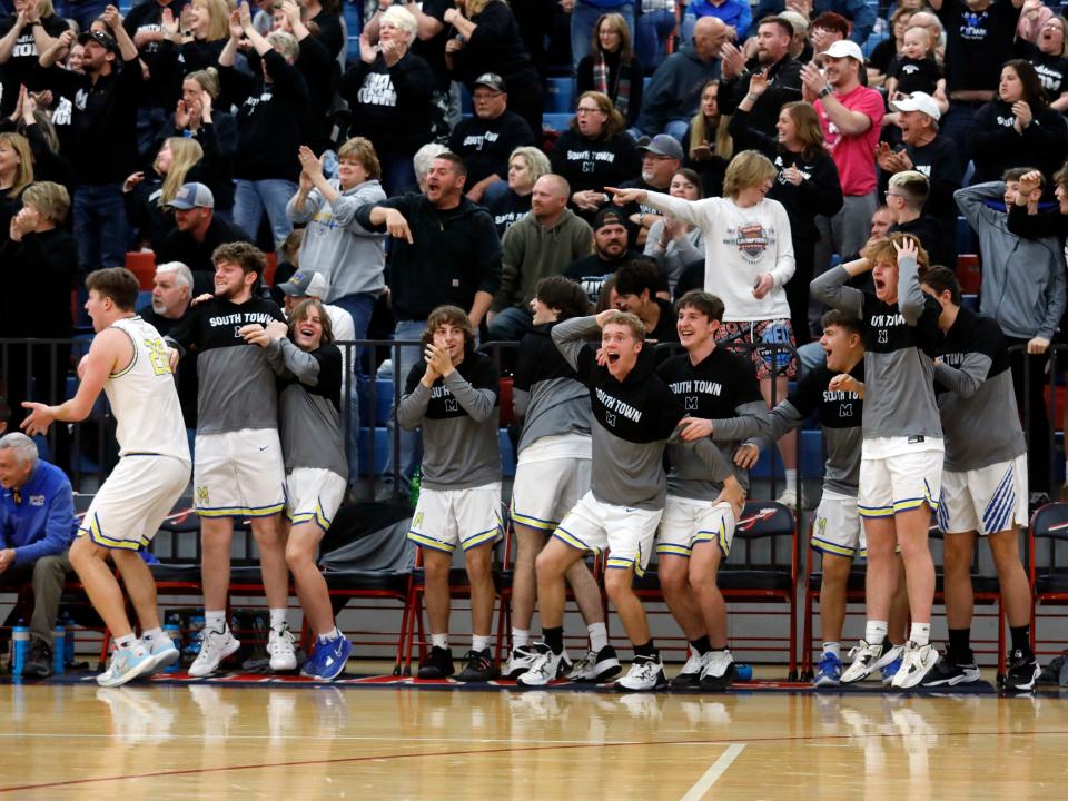 The bench comes to life following an Alex Bobb 3-pointer during the fourth quarter of Maysville's 72-51 win against East Liverpool in a Division II district final on March 5, 2023, at Indian Valley High School in Gnadenhutten. Bobb scored 34 points as Maysville reached its first regional tournament since 2008.