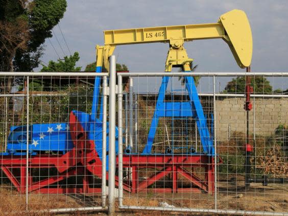 An oil pumpjack painted with the colours of the Venezuelan flag (Reuters)
