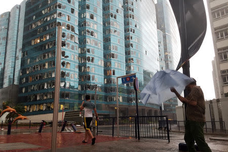 Damaged windows of the One Harbourfront office tower are seen following Typhoon Mangkhut, in Hong Kong, China September 16, 2018. REUTERS/Bobby Yip