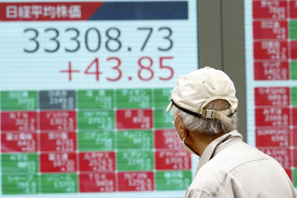 A person looks at an electronic stock board showing Japan's Nikkei 225 index at a securities firm Friday, June 23, 2023, in Tokyo. Asian shares sank sharply Friday after several central banks around the world cranked interest rates higher in their fight against inflation. (AP Photo/Eugene Hoshiko)