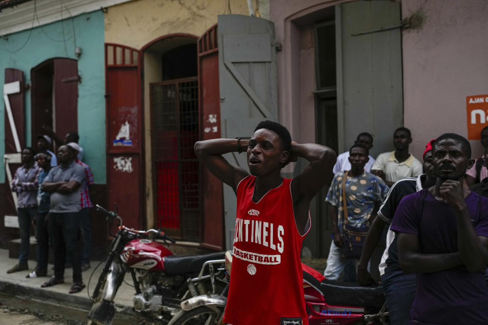 Men watch a soccer match televised in a shop in Cap-Haitien, Haiti, Wednesday, April 17, 2024. (AP Photo/Ramon Espinosa)