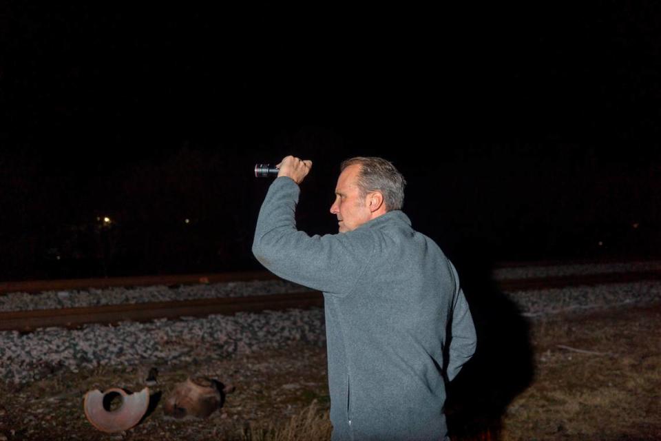 Volunteer Steve Montgomery walks along train tracks to search for unsheltered individuals during the Point in Time Count on Thursday, Jan. 27, 2023, in Fort Worth. The Tarrant County Homeless Coalition deployed hundreds of volunteers throughout the city to connect with unsheltered residents and provide resources for housing.