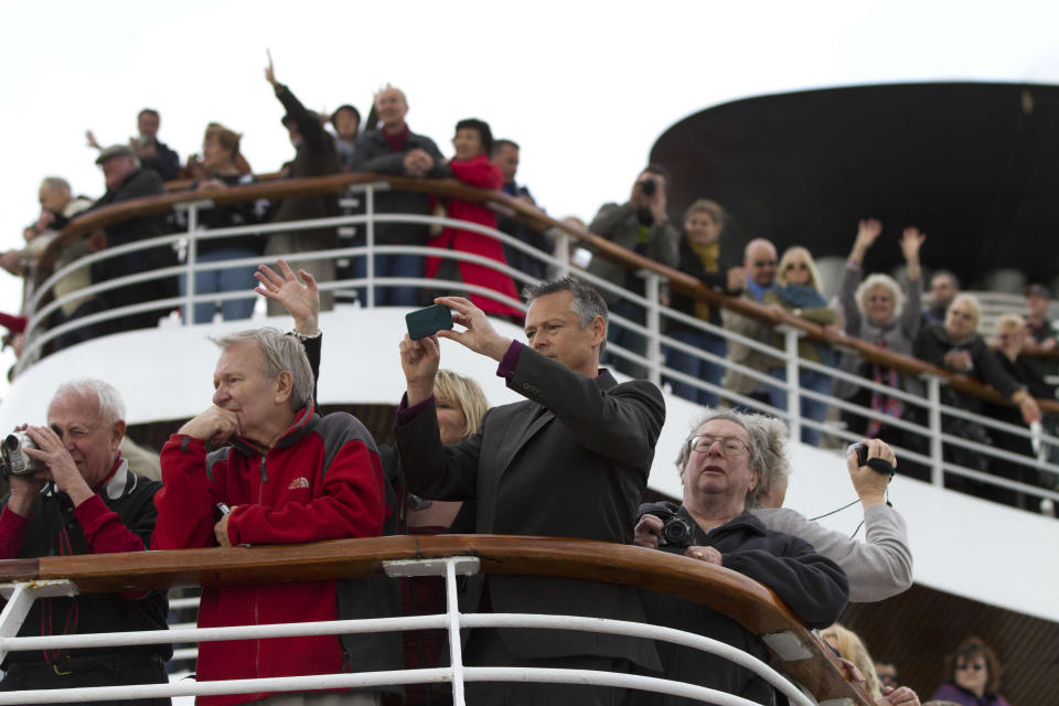 In this photo taken Sunday, April 8, 2012, passengers gather on deck as the MS Balmoral Titanic memorial cruise ship sails from Southampton, England. A cruise carrying relatives of some of the more than 1,500 people who died aboard the Titanic nearly 100 years ago set sail from England on Sunday to retrace the ship's voyage, including a visit to the location where it sank (AP Photo/Lefteris Pitarakis)