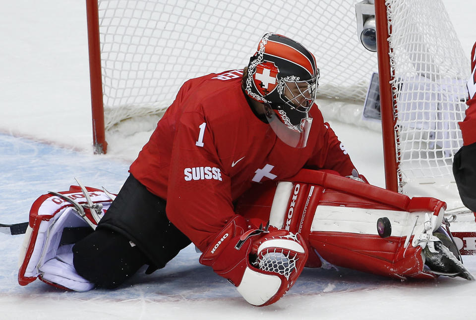 Switzerland goaltender Jonas Hiller blocks a shot by the Czech Republic in the second period of a men's ice hockey game at the 2014 Winter Olympics, Saturday, Feb. 15, 2014, in Sochi, Russia. (AP Photo/Petr David Josek)