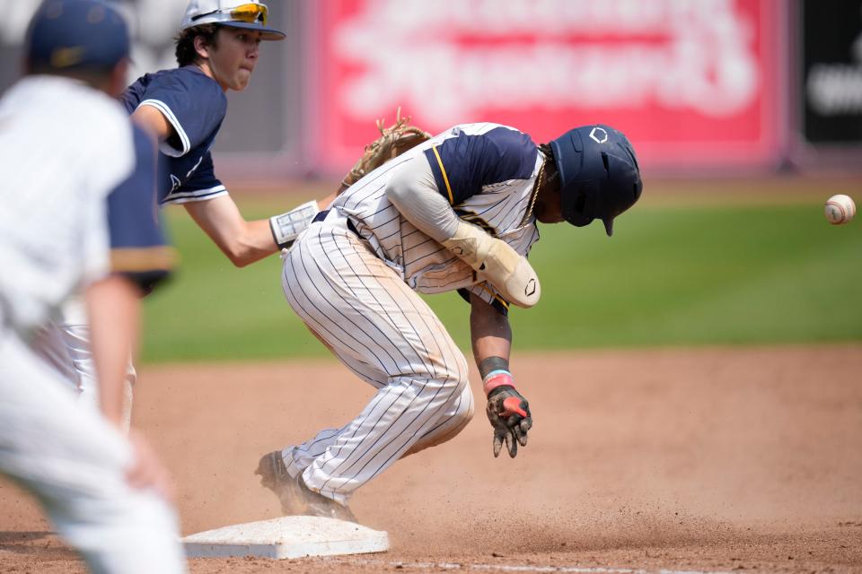 Moeller's C.J. Richard (1) runs safely to third base defended by Olentangy Orange's Keegan Knupp (8) during the Division I state final baseball game between Olentangy Orange and Moeller at Canal Park.