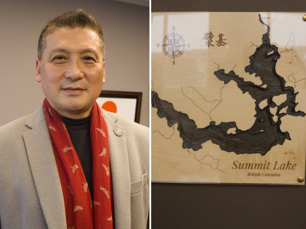 Prince George Mayor Simon Yu in his office with a framed map of Summit Lake, which inspired his Chinese name for the city.  (Nadia Mansour/CBC - image credit)