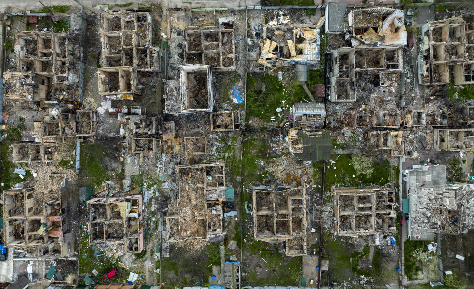 FILE - Destroyed houses are photographed in Irpin, on the outskirts of Kyiv, Ukraine, Saturday, April 30, 2022. As milestones go, the first anniversary of Russia's invasion of Ukraine is both grim and vexing. It marks a full year of killing, destruction, loss and pain felt even beyond the borders of Russia and Ukraine. (AP Photo/Emilio Morenatti, File)