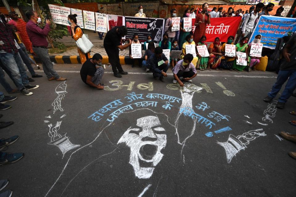 Demonstrators paint a floor mural to protest against rape in India (AFP via Getty Images)