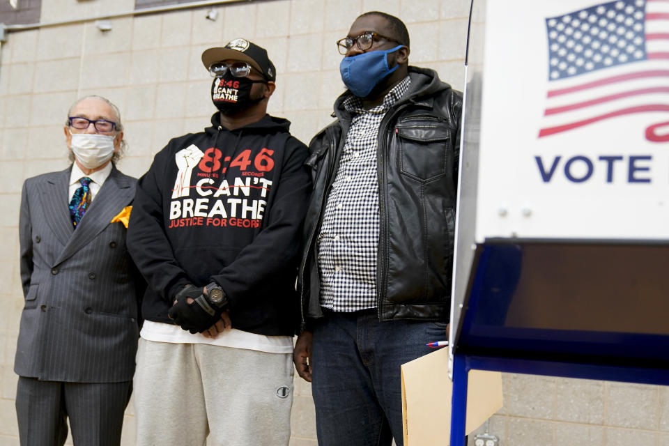 Terrence Floyd, brother of George Floyd, second from left, waits to vote with Sandy Rubenstein, left, and Rev. Kevin McCall, Tuesday, Nov. 3, 2020, in the Brooklyn borough of New York. (AP Photo/Frank Franklin II)