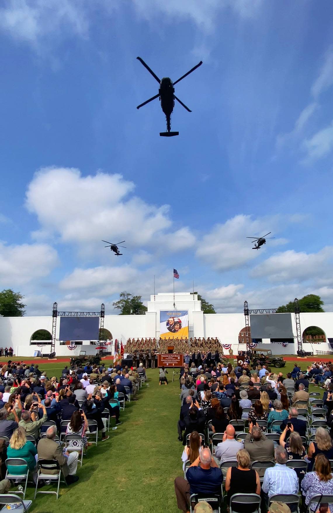 Three Blackhawk helicopters fly over Doughboy Stadium after the new Fort Moore sign was unveiled Thursday morning. Fort Benning was redesignated as Fort Moore during the ceremony. 05/11/2023