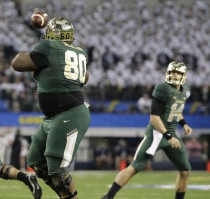 Baylor offensive guard LaQuan McGowan (80) catches a touchdown pass from quarterback Bryce Petty (14) during the second half of the Cotton Bowl NCAA college football game against Michigan State Thursday, Jan. 1, 2015, in Arlington, Texas. (AP Photo/LM Otero)