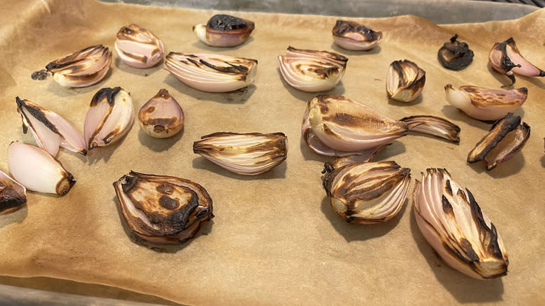 broiled caramelized shallots on parchment lined baking sheet