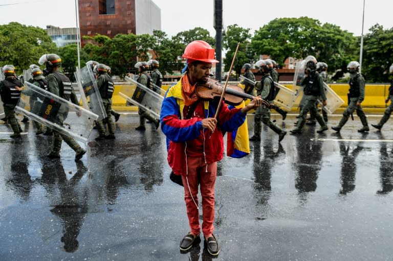 Opposition demonstrator Wuilly Arteaga plays the violin during a protest against President Nicolas Maduro in Caracas, on May 24, 2017