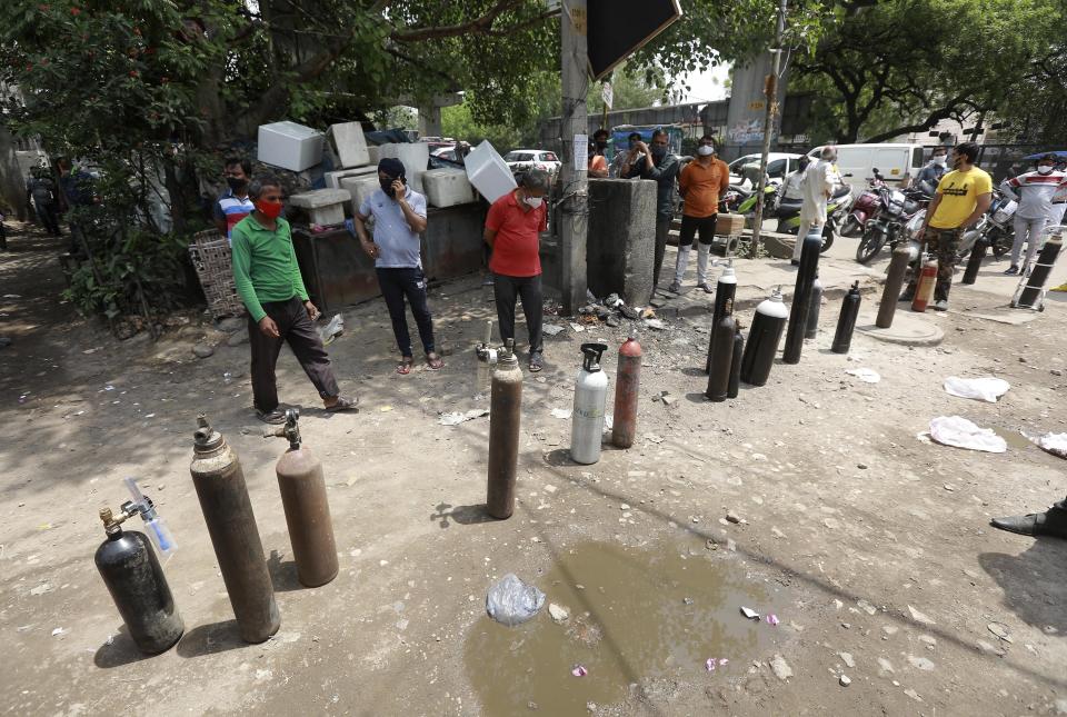 Oxygen tanks are left in a queue to be refilled in New Delhi, India, Friday, April 23, 2021. India put oxygen tankers on special express trains as major hospitals in New Delhi on Friday begged on social media for more supplies to save COVID-19 patients who are struggling to breathe. India’s underfunded health system is tattering as the world’s worst coronavirus surge wears out the nation, which set another global record in daily infections for a second straight day with 332,730. (AP Photo)