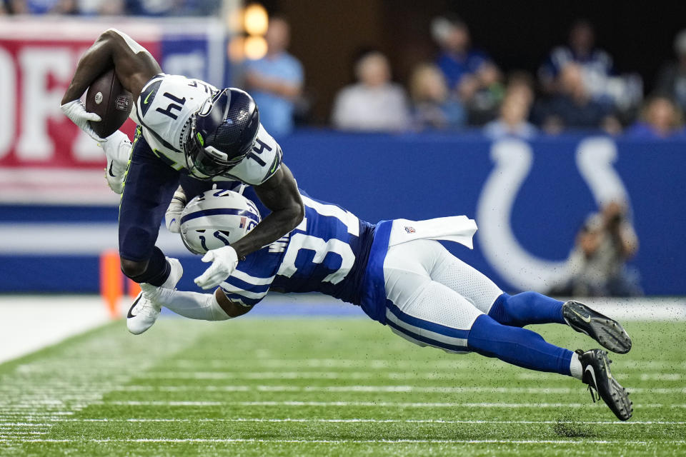 Seattle Seahawks wide receiver DK Metcalf (14) is tackled by Indianapolis Colts safety Khari Willis (37) during the second half of an NFL football game in Indianapolis, Sunday, Sept. 12, 2021. (AP Photo/AJ Mast)