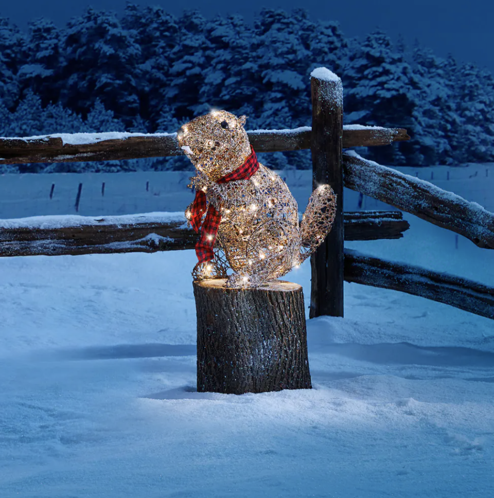 Canvas Canadian Cabin Beaver Christmas Decoration outside in snowy backyard (Photo via Canadian Tire)