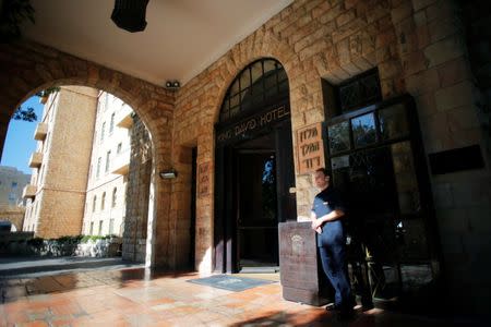 FILE PHOTO: A hotel employee stands at the entrance to the King David Hotel in Jerusalem, June 19, 2018. REUTERS/Ammar Awad/File Photo