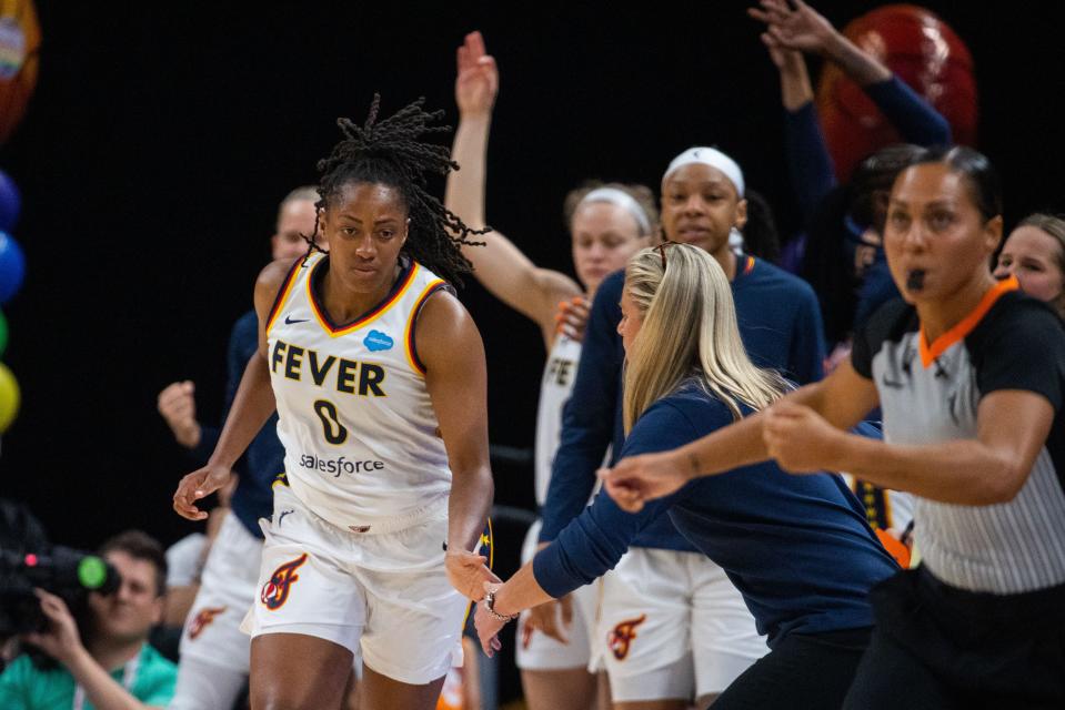 Jun 4, 2023; Indianapolis, Indiana, USA; Indiana Fever guard Kelsey Mitchell (0) celebrates a three point basket with the bench in the second half against the Las Vegas Aces at Gainbridge Fieldhouse. Mandatory Credit: Trevor Ruszkowski-USA TODAY Sports