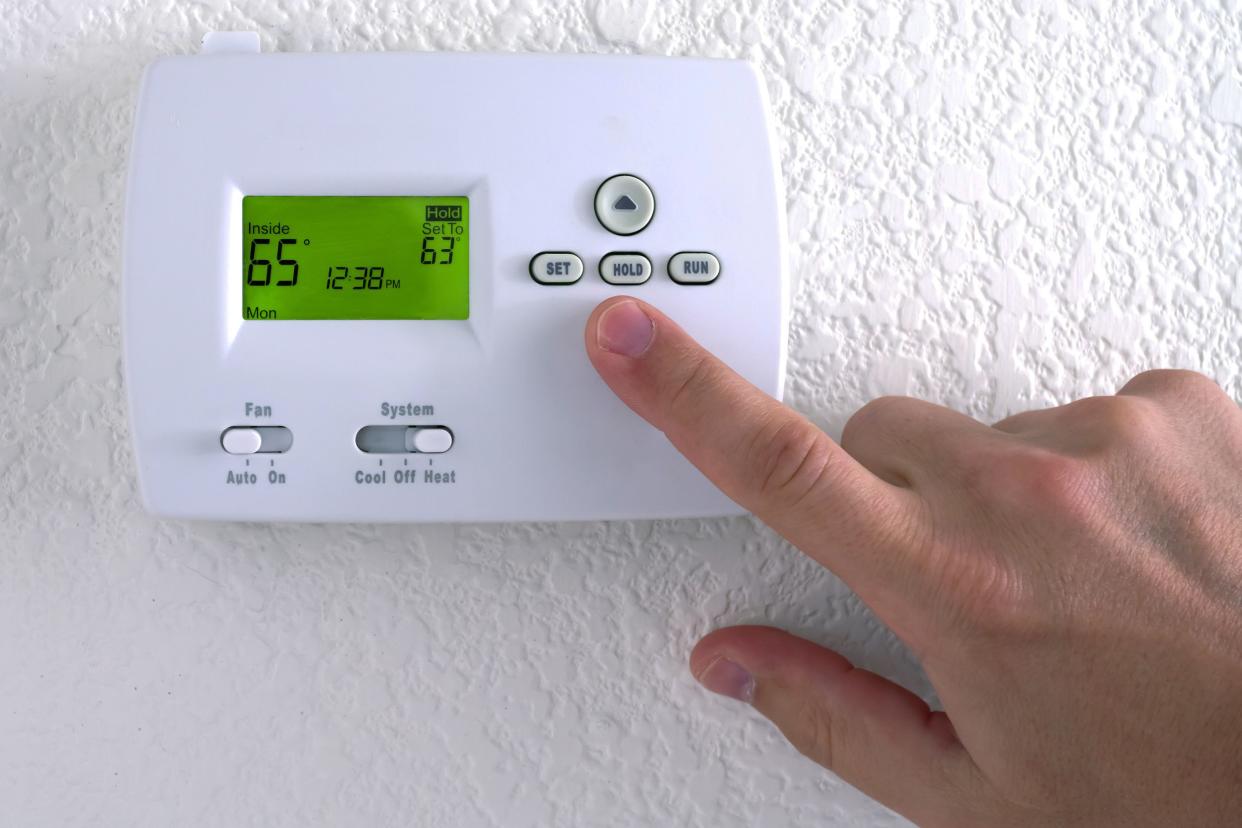 pushing down temperature of thermostat