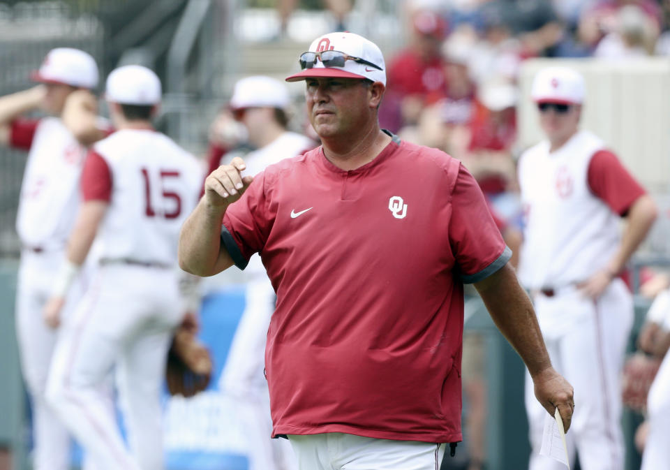 FILE - Oklahoma head baseball coach Skip Johnson looks to his players before an NCAA college baseball tournament super regional game against Virginia Tech Saturday, June 11, 2022, Blacksburg, Va. Oklahoma clinched its first Big 12 regular-season championship with a three-game sweep of Baylor over the weekend. (AP Photo/Matt Gentry, File)