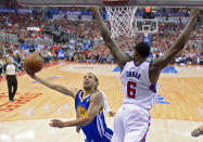 Golden State Warriors guard Stephen Curry, left, puts up a shot as Los Angeles Clippers center DeAndre Jordan defends during the first half in Game 1 of an opening-round NBA basketball playoff series, Saturday, April 19, 2014, in Los Angeles. (AP Photo/Mark J. Terrill)