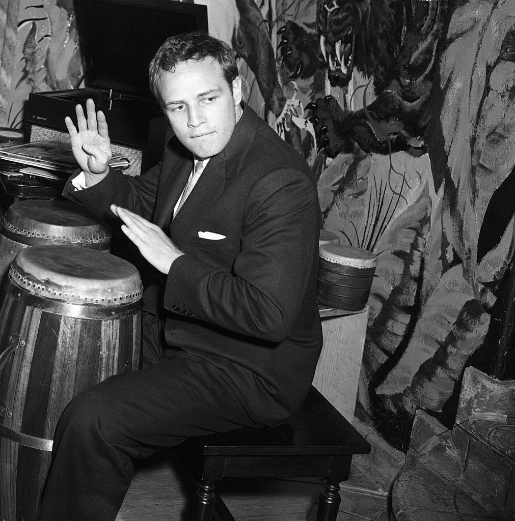 Marlon Brando plays the bongos in his Hollywood Hills home during a visit by television's Edward R. Murrow