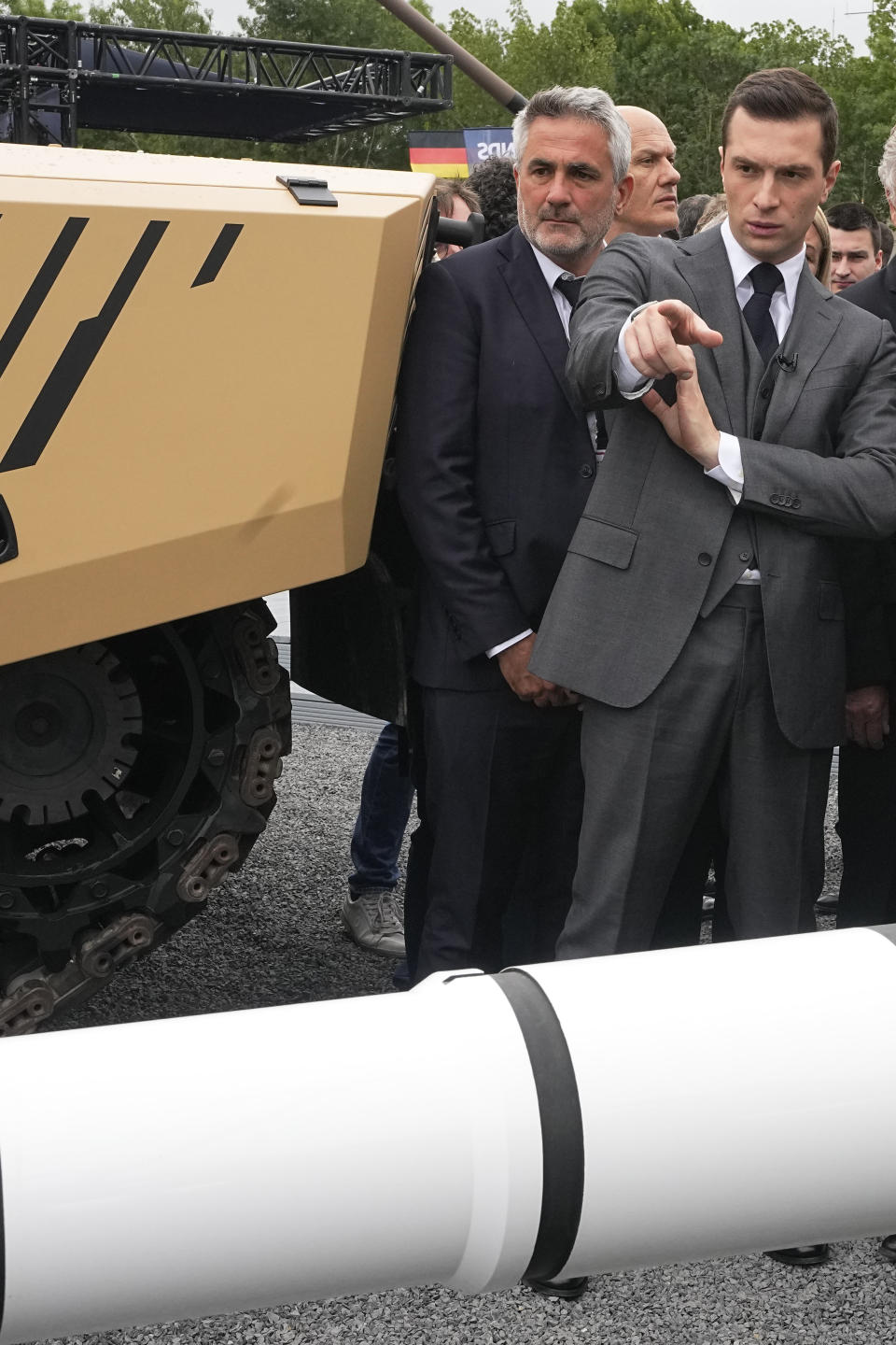 Jordan Bardella, president of the far-right National Front party, points to an Ascalon 120mm gun at the Eurosatory Defense and Security exhibition, Wednesday, June 19, 2024 in Villepinte, north of Paris. Jordan Bardella, hoping to become France's prime minister, appealed Tuesday to voters to hand his party a clear majority after French President Emmanuel Macron's announcement on June 9 that he was dissolving France's National Assembly, parliament's lower house.( AP Photo/Michel Euler)