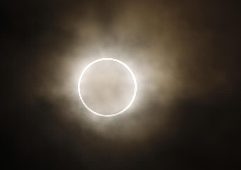 An annular eclipse is viewed from a waterfront park in Yokohama, Japan, near Tokyo, Monday, May 21, 2012.