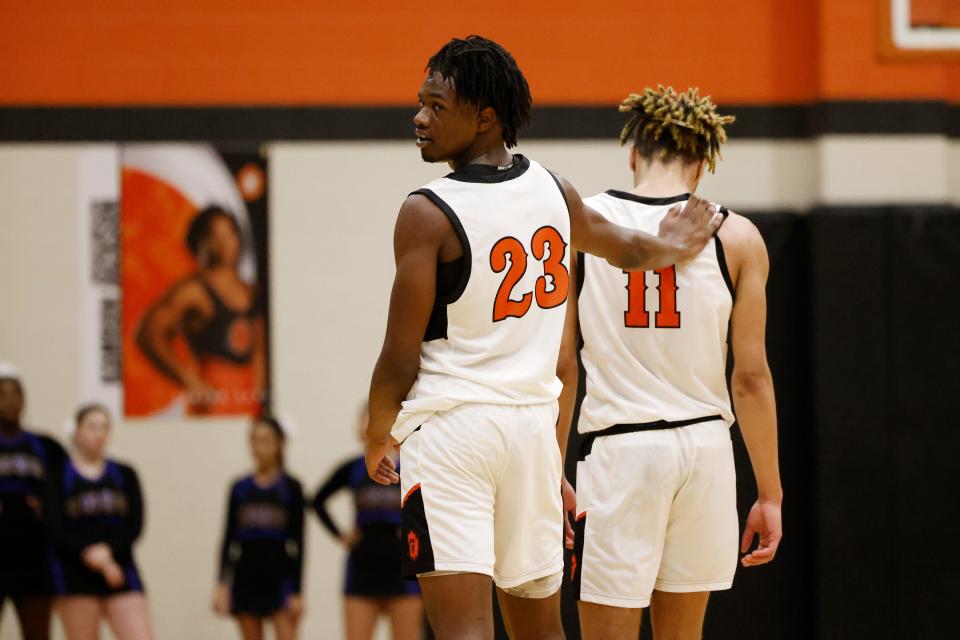 Douglass' Jaden Nickens puts his hand on Davon Scott's shoulder during a high school basketball game Friday, Feb. 2, 2024, at Douglass High School.