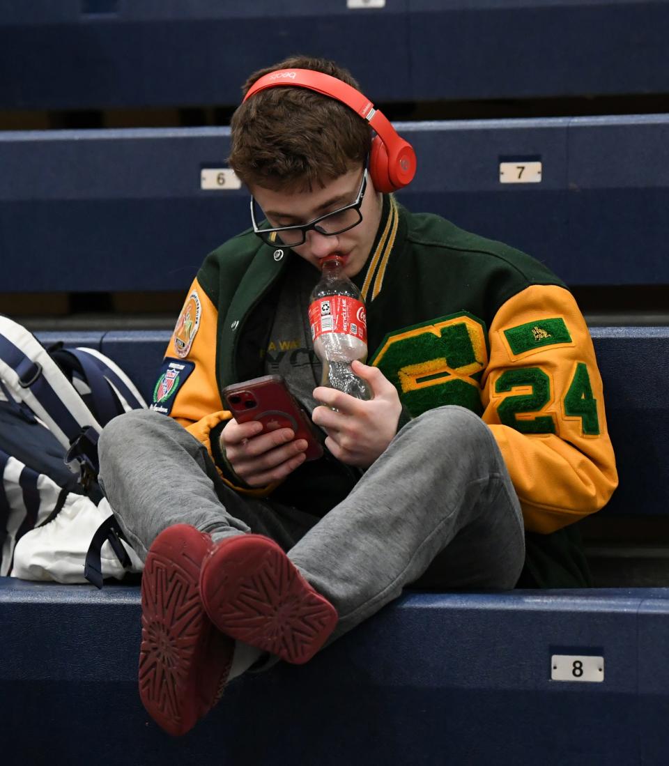 Adam Gelman uses his headphones and music to focus before and after matches.
