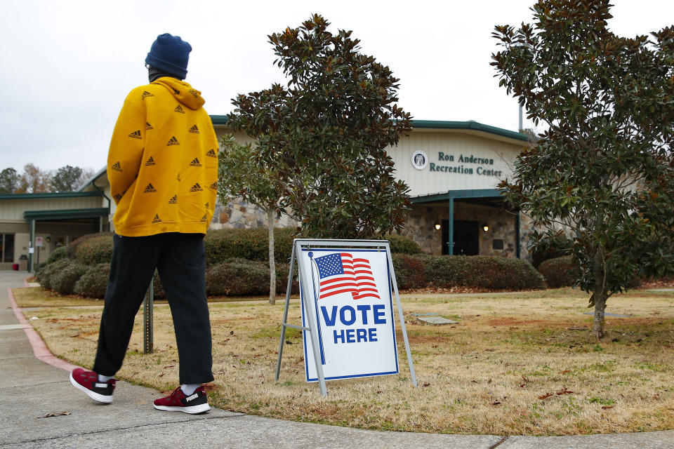 A voter walks to the entrance during early voting for the Senate runoff election, at Ron Anderson Recreation Center, Thursday, Dec. 17, 2020, in Powder Springs, Ga. (AP Photo/Todd Kirkland)