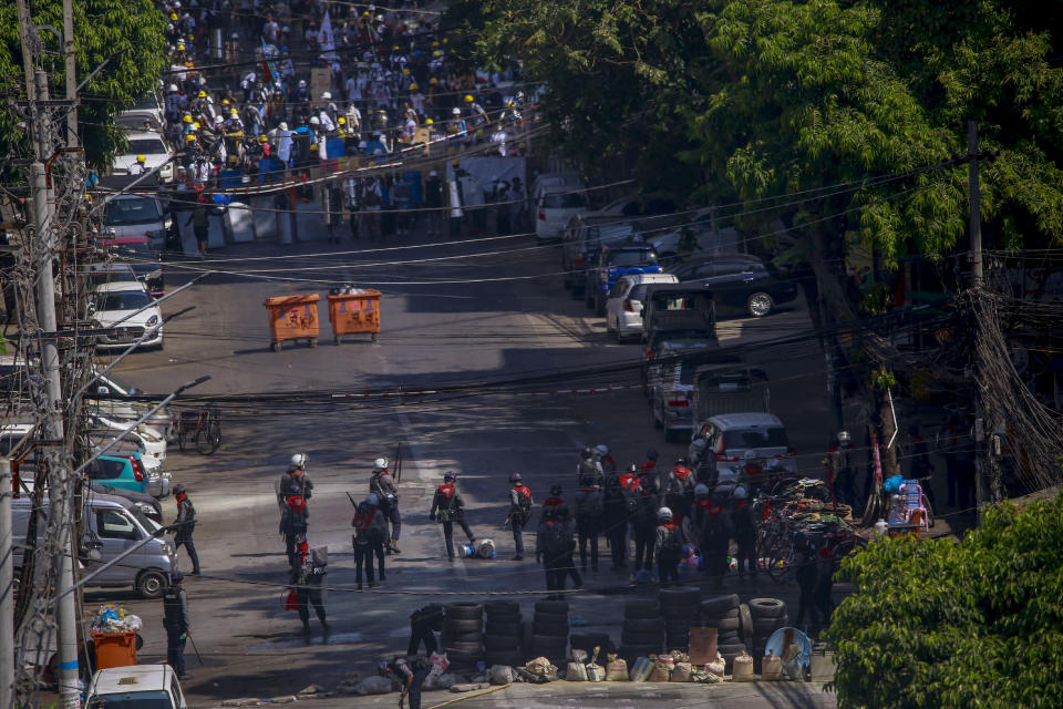 Anti-coup protesters standing behind barricades standoff with a group of police in Yangon, Myanmar, Thursday, March 4, 2021. Demonstrators in Myanmar protesting last month's military coup returned to the streets Thursday, undaunted by the killing of at least 38 people the previous day by security forces. (AP Photo)