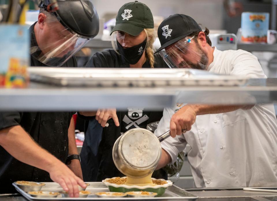 David Lee (left), and fellow sous chef Gannon Cooper help Josh Cooper with his sugar cream pie creation during the filming of World Food Championships, at Ivy Tech Community College, Indianapolis, Sunday, Aug. 9, 2020. This final round of the weekend's competition pits three cooks in a sugar cream pie contest. 