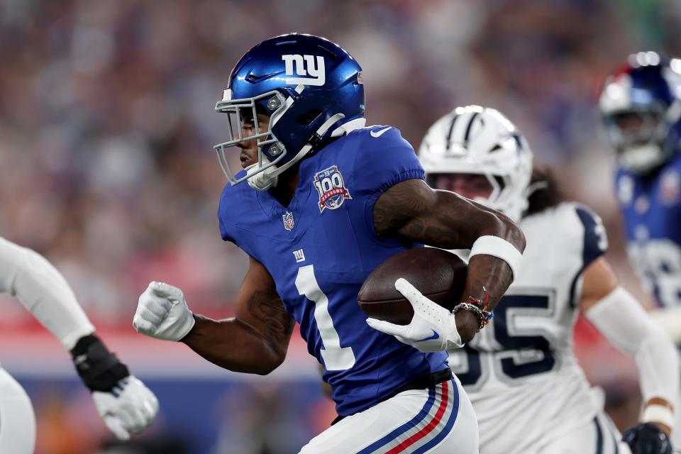 EAST RUTHERFORD, NEW JERSEY - SEPTEMBER 26: Malik Nabers #1 of the New York Giants carries the ball during the first quarter against the Dallas Cowboys at MetLife Stadium on September 26, 2024 in East Rutherford, New Jersey. (Photo by Sarah Stier/Getty Images)