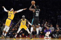 Portland Trail Blazers forward Justise Winslow, right, shoots as Los Angeles Lakers guard Russell Westbrook, left, and forward Wenyen Gabriel defend during the first half of an NBA basketball game Wednesday, Nov. 30, 2022, in Los Angeles. (AP Photo/Mark J. Terrill)