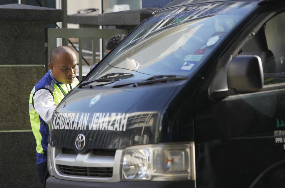 A police officer checks on a van outside the forensic department at Kuala Lumpur Hospital in Kuala Lumpur, Malaysia, Saturday, Feb. 25, 2017. According to police Friday, forensics stated that the banned chemical weapon VX nerve agent was used to kill Kim Jong Nam, the North Korean ruler's outcast half brother who was poisoned last week at the airport. (AP Photo/Daniel Chan)