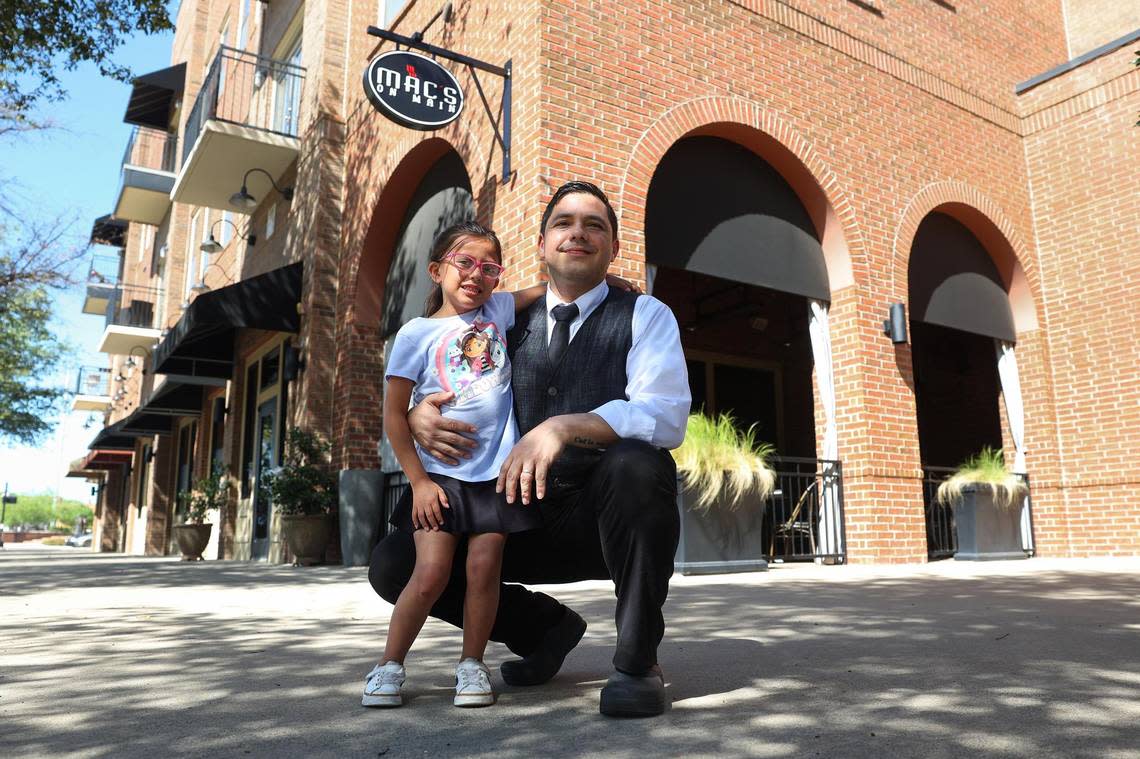 Juan Cordova and his daughter, Camila, 6, in front of Mac’s on Main, his place of employment, on Friday, April 5 in Grapevine. The full price of child care became too expensive for his family without financial aid, Cordova said, and now he and his wife — who is also a server — work opposite shifts and rely on relatives to make their child care situation work. Amanda McCoy/amccoy@star-telegram.com