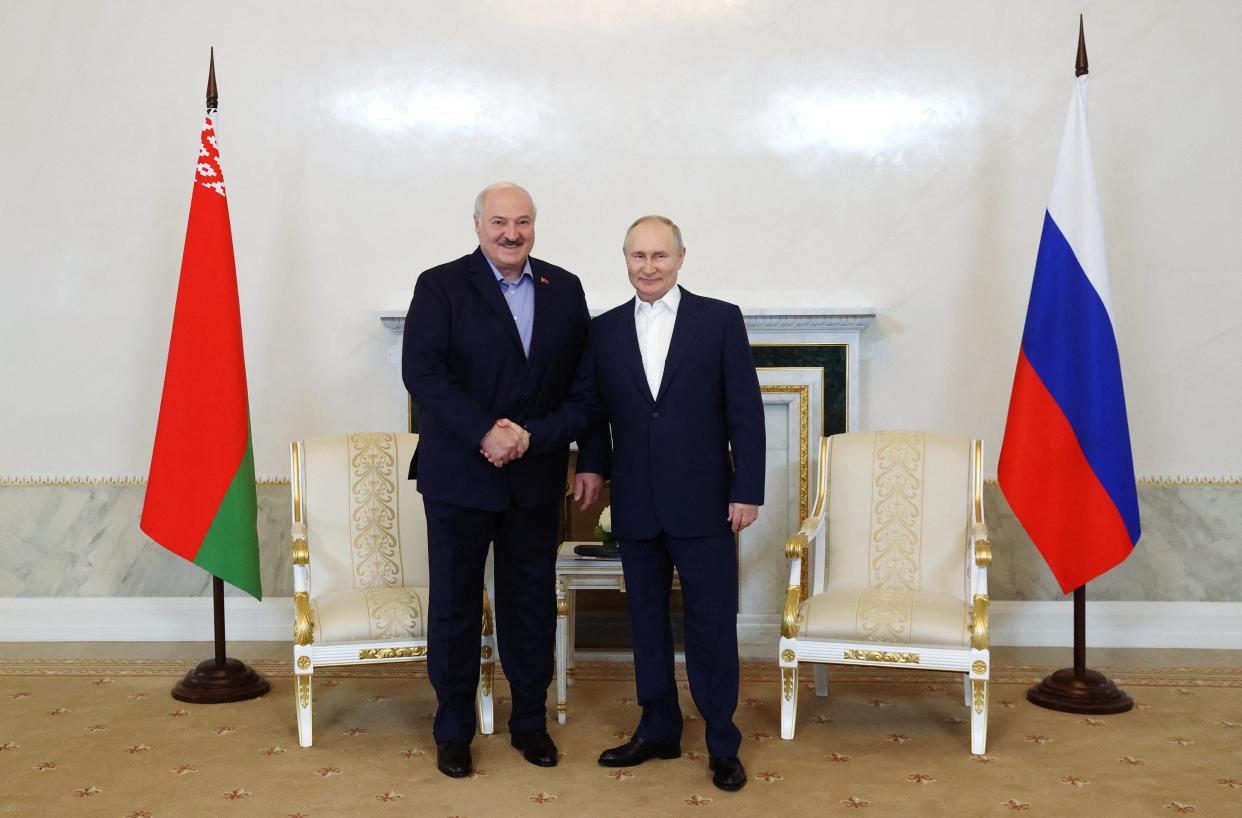 Russian president Vladimir Putin shakes hands with Belarusian president Alexander Lukashenko (via REUTERS)